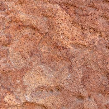 Red rough stone texture background. Material construction and architectural detail.