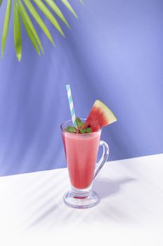 Fresh water melon juice and watermelon slice on color background. summer drink.