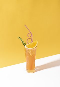 Cold and refreshing orange punch cocktail with orange slice on color background. summer drink.