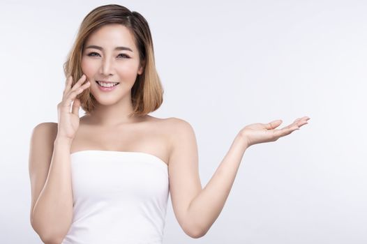 Beauty Young asian woman with perfect facial skin. Gestures for advertisement treatment spa and cosmetology.