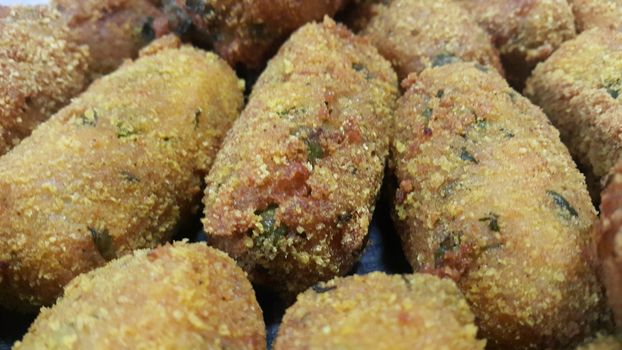 Closeup perspective view of home made spicy and delicious croquettes served with tea or other dishes during parties as fast food.