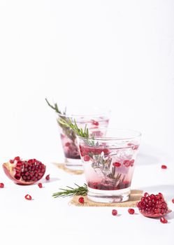 Pomegranate juice with ripe pomegranate on white background. summer drink.