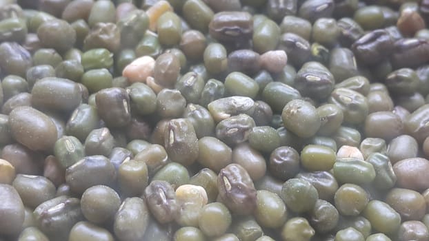 Closeup view of green whole Mung bean or green gram, maash, or moong. It is used as an ingredient in both savory and sweet dishes.