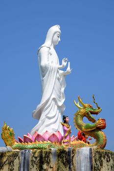 White guanyin stand on blue sky background.