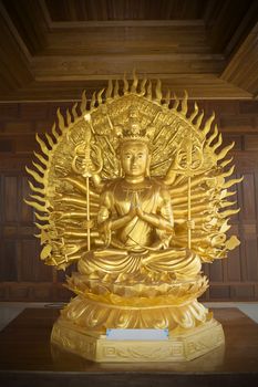 Golden statue of Guan Yin with thousand hands in temple is worship of the buddhist people.