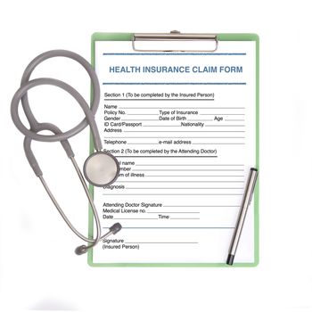 Blank insurance claim form on clipboard with stethoscope and pen.
