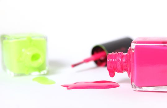 Pink and Yellow Neon Nail Polish on White Background