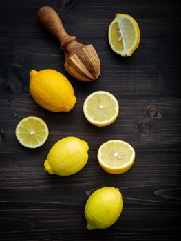Fresh lemons and  lemons leaves on shabby wooden background.