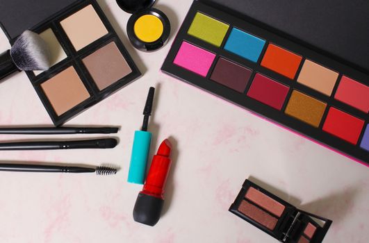 Colorful Cosmetics and Brushes on paper background