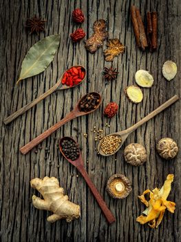 Ingredients for Chinese herbal soup on shabby wooden background .