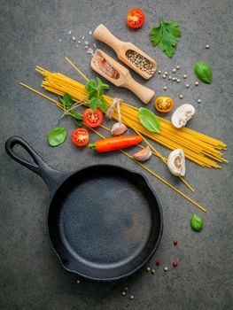 Italian food and menu concept. Spaghetti with ingredients sweet basil ,tomato ,garlic peppercorn and champignon on dark background flat lay and copy space.