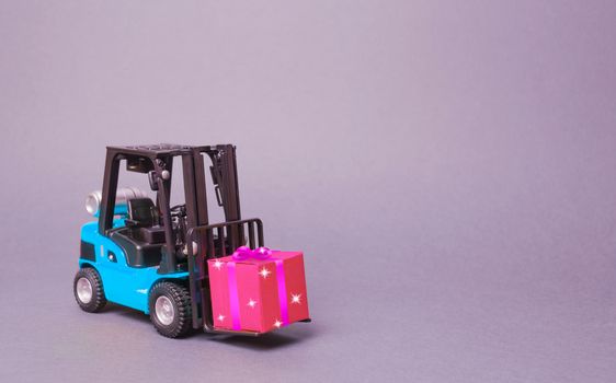 Blue forklift truck carries a pink gift box with a bow. Purchase and delivery of a present. retail, discounts and contests. contest promotions. Increase sales and attract new customers.