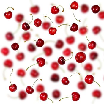 Falling Fresh cherries with stems background. Creative beautiful red ripe cherries summer berries pattern selective focus.    