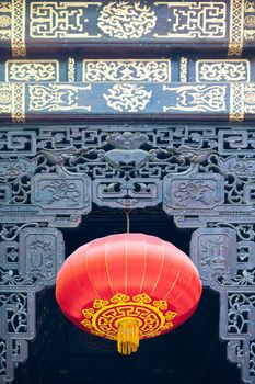 Red chinese lanterns hanging on a decorated door in LuoHanSi buddhist temple, Chongqing, China