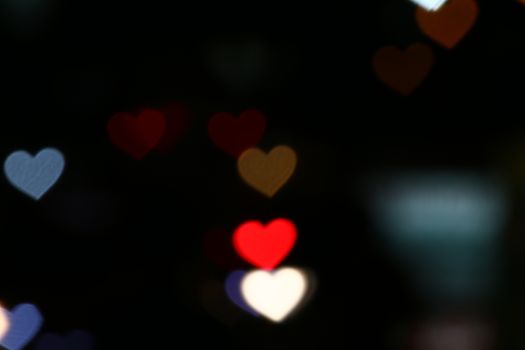 Valentines Colorful heart-shaped on black background lighting bokeh for decoration at night backdrop wallpaper blurred valentine, Love Pictures background, Lighting heart shaped soft at night abstract