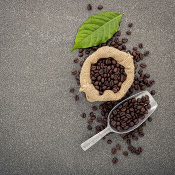 Dark roasted coffee beans on stone background. Top view with copyspace.
