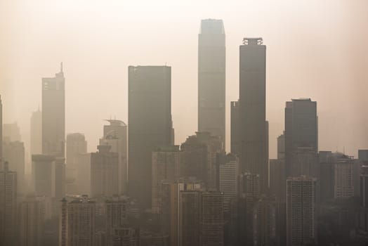 Big city skyline in smog with skyscrapers silouhettes