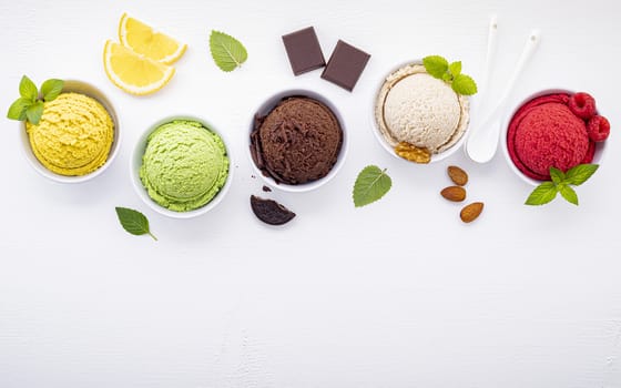 Various of ice cream flavor ball blueberry ,lime ,pistachio ,almond ,orange ,chocolate and vanilla set up on white wooden background . Summer and Sweet menu concept.