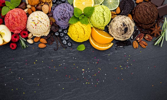 Various of ice cream flavor ball blueberry ,lime ,pistachio ,almond ,orange ,chocolate and vanilla set up on dark stone background . Summer and Sweet menu concept.