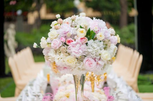 Wedding decoration with flowers on a table outdoors