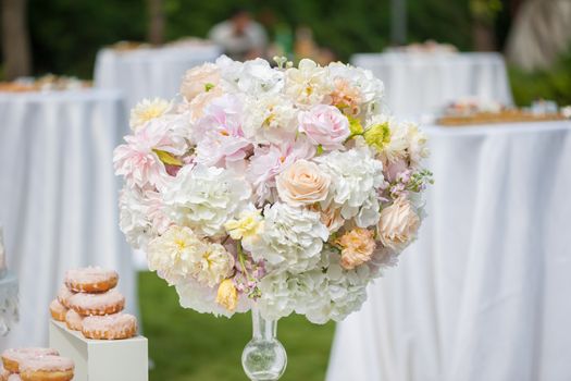 Wedding decoration with flowers and food on a table outdoors