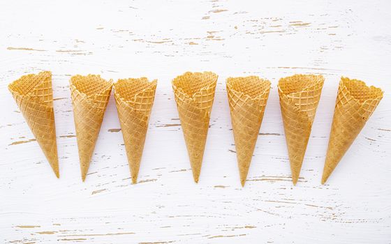 Flat lay ice cream cones collection on shabby wooden background . Blank crispy ice cream cone with copy space for sweets menu design.