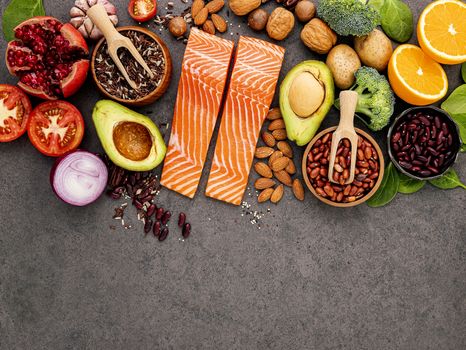 Ingredients for the healthy foods selection on dark background. Balanced healthy ingredients of unsaturated fats and fiber for the heart and blood vessels.