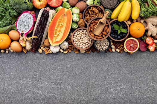 Ingredients for the healthy foods selection. The concept of healthy food set up on dark stone background.