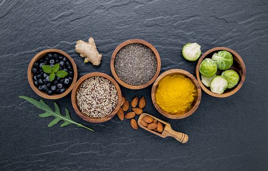 Super foods on in wooden bowl. Selection food and healthy food set up on dark stone background.