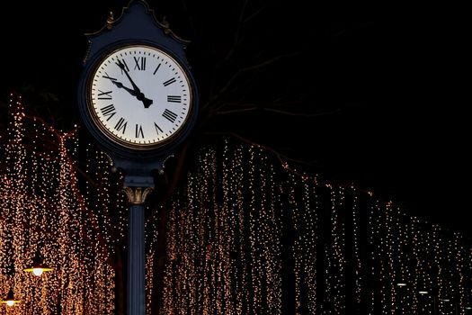 clock tower on street park night with bokeh lighting gold yellow background romantic nightlife