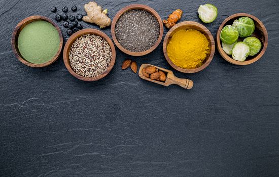 Super foods on in wooden bowl. Selection food and healthy food set up on dark stone background.