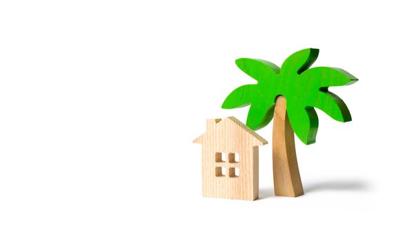 Wooden palm tree and hut on an isolated background. Conceptual leisure and vacation. Rental homes and properties in the resort. Romantic travel. Entertainment and relaxation.
