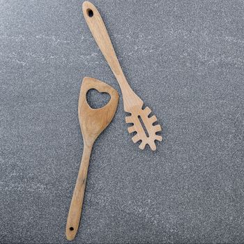 Pasta noodle spoon , Pasta scoop ladle  and  spatula on dark granite background with copy space.