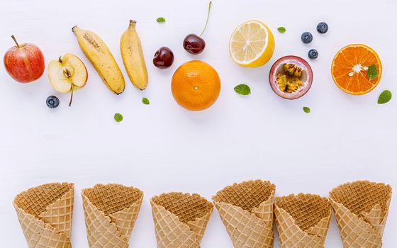 Flat lay various fresh fruits blueberry ,strawberry ,orange ,banana ,passion fruit ,apple and cherry setup on white background . Summer and Sweet menu concept.