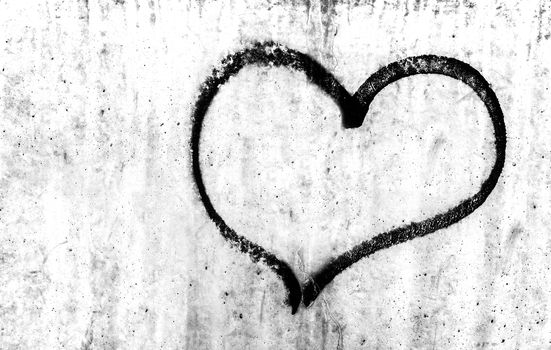 Heart painted on grunge cement wall background, love concept.