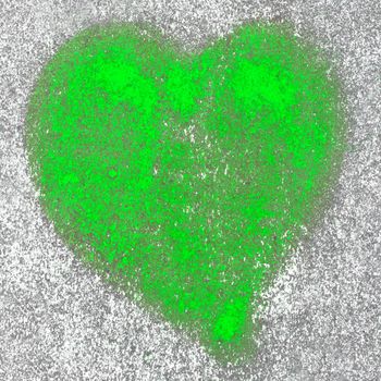 Green heart spray painted on a wall in the background