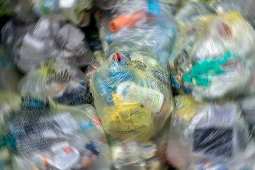 Close Up of garbage and waste in transparent bags. Radial blur effect.