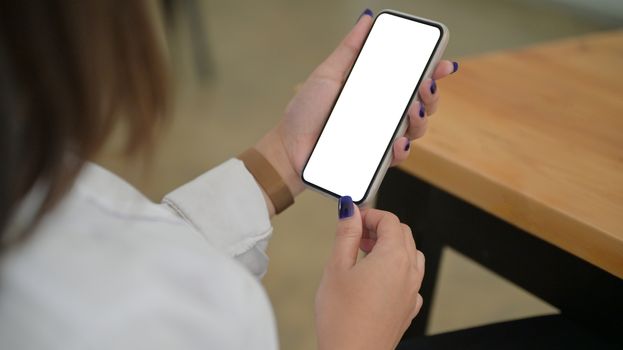 Cropped shot of Smartphone screen blank in young woman hand.