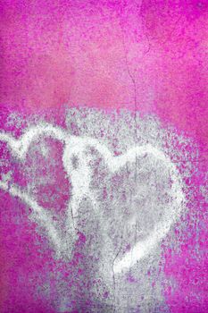 Grungy pair of faded hearts. Pink wall background. For your flyers, greetings card and more.