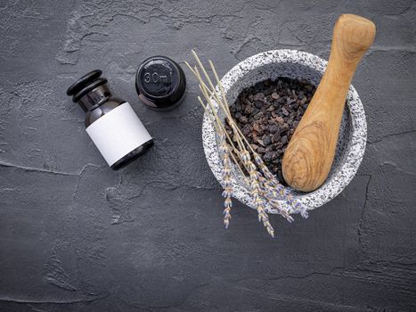 Aromatic  bath salt with lavender flower on dark concrete background. Himalayan salt commonly used in cooking and for bath products such as bath salts.