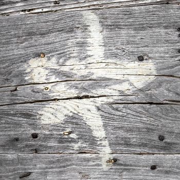 Old star painted on cracked wood. Grungy Christmas look.