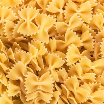 Uncooked italian farfalle. Background of pasta closeup. Raw food background or texture close up.