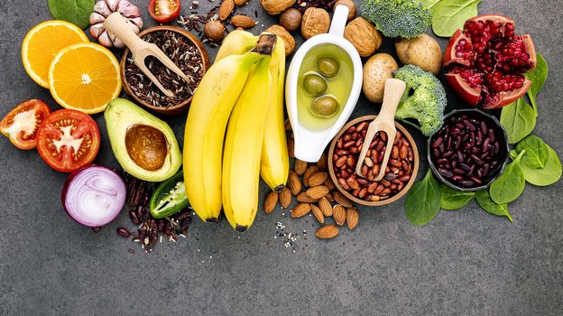 Ingredients for the healthy foods selection on dark background. Balanced healthy ingredients of unsaturated fats and fiber for the heart and blood vessels.