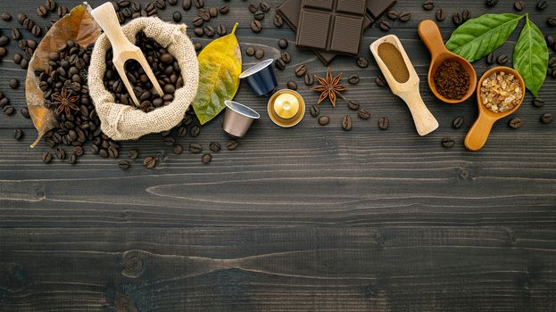 Coffee beans ,coffee capsule and coffee powder on dark wooden background. Top view with copy space.