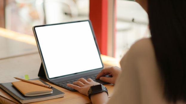 Young business women are using blank screen laptop with office equipment in modern office.