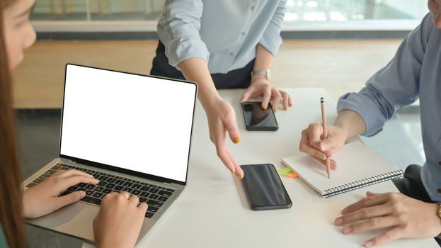 Business team briefed the concepts before the meeting with customers at the modern office equipped with laptop computer.