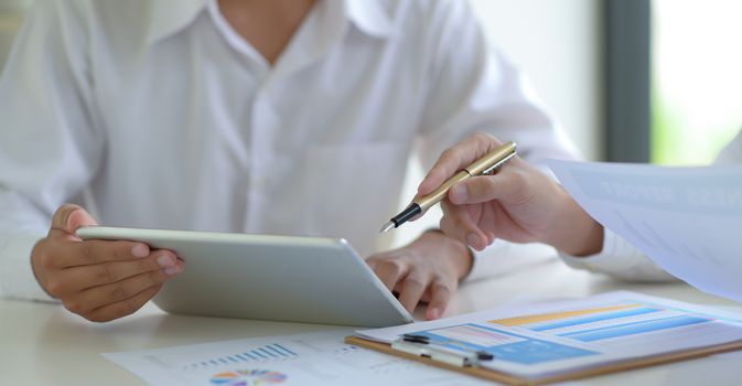 Cropped shot of Stock market experts use tablet to follow the news to assess the volatile stock market situation.