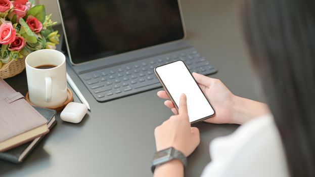 Close-up view of businesswoman searching for important information with a smartphone for her new project.