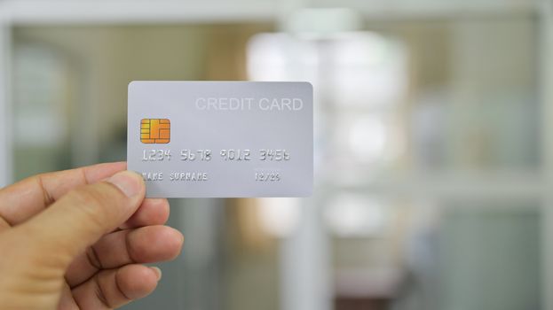 Close - up shot of Hand showing credit card.