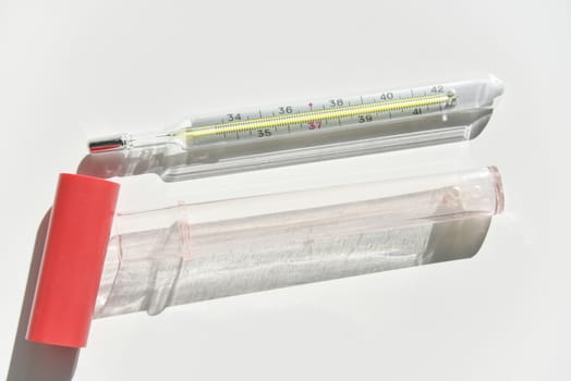 mercury thermometer with the white case on the white background